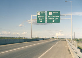Pair of overhead signs, one for Alaska 2 northbound for Steese Expy, the other for Alaska 2 southbound for North Pole, Delta Jct