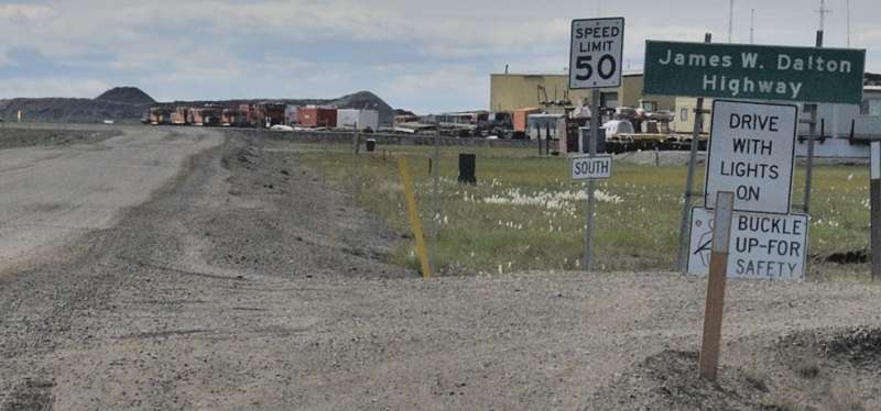 James W. Dalton Highway sign, and others including apparently missing AK 11 marker, southbound leaving Deadhorse