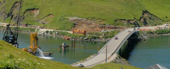 Existing wood-decked Bridge to the Other Side on the right, with its replacement under construction to the left