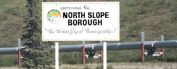 North Slope Borough boundary sign, in front of pipeline