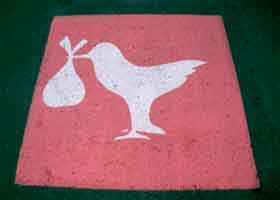 Pink pavement marking, with picture of stork carrying baby