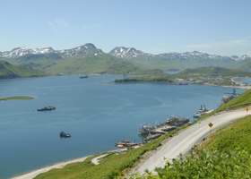 View of west end of harbor, with part of Ulakta Drive to lower right, and mountains and western Amaknak Island in the background